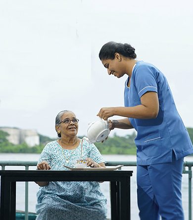 female caregiver helping elderly